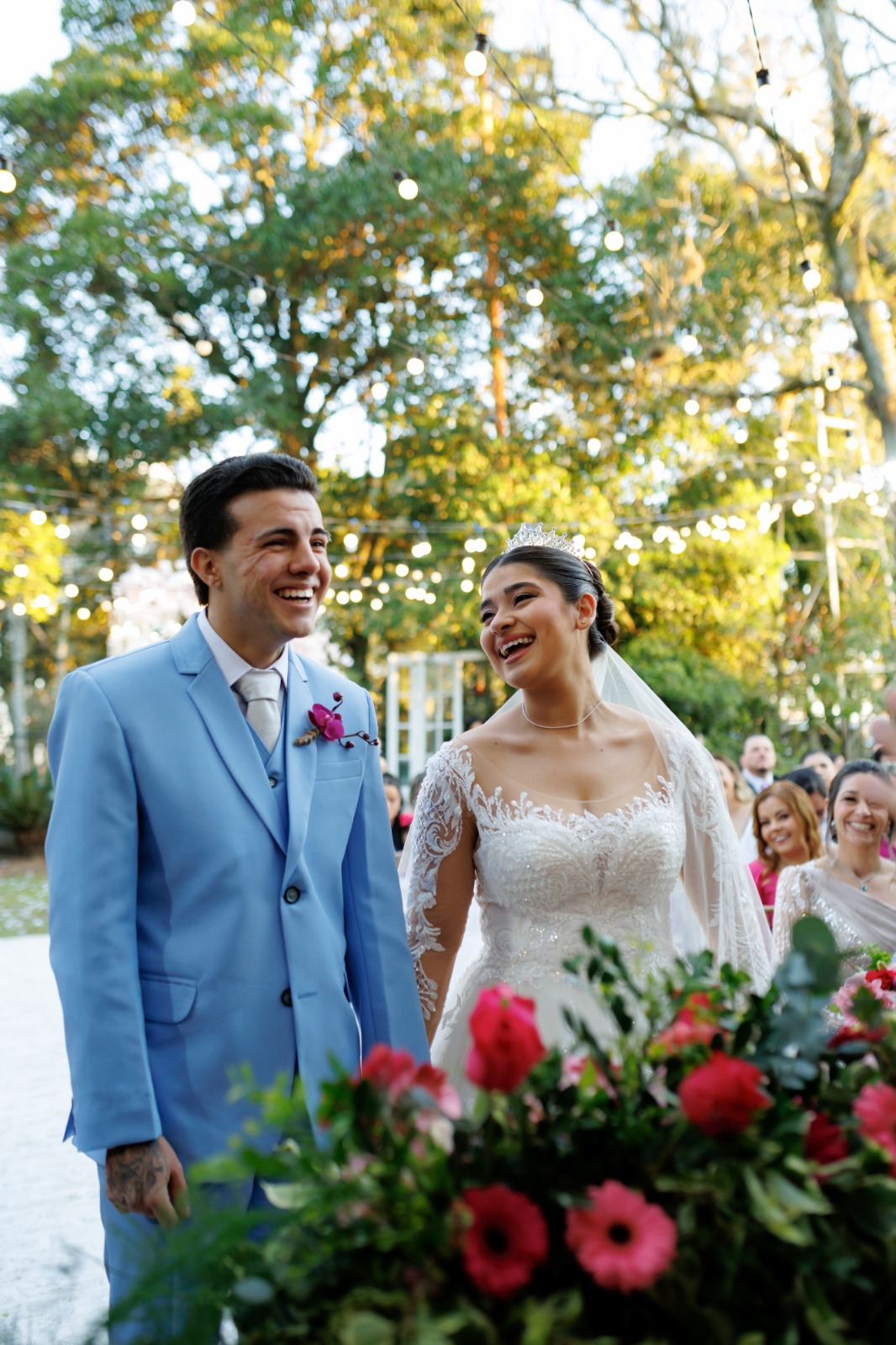 Noivos entre os convidados no jardim